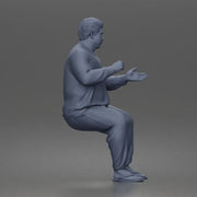 Asian Man sits gesturing while wearing casual sweater pants flip flops comfortably - Only-Games