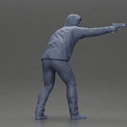 Man in hoodie pointing gun while raising hand in defensive gesture - Only-Games
