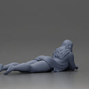 Girl with long hair in green dress lying with calm on the beach - Only-Games