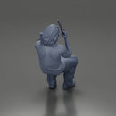 Man sitting with gun in hand pointing forward calmly - Only-Games