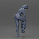 Woman in white top carefully wearing grey pants with balance - Only-Games