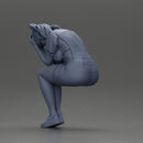 Crying girl sitting low in orange dress with head in hands - Only-Games