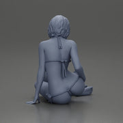 Woman in green bikini sitting gracefully on the floor with a relaxed pose - Only-Games