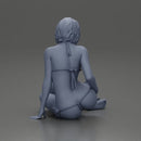 Woman in green bikini sitting gracefully on the floor with a relaxed pose - Only-Games