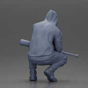 Gangster crouching low in green hoodie holding bat planning move - Only-Games