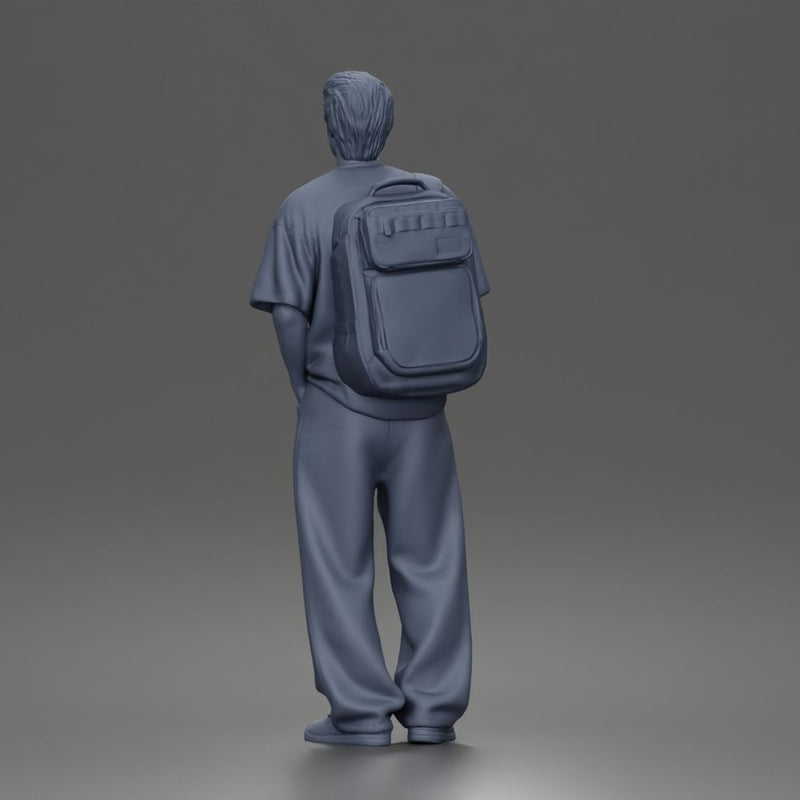 Student standing with backpack wearing oversized tee and baggy jeans