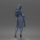 Woman standing In Belted Pinafore Dress Over Blouse With Heeled Sandals