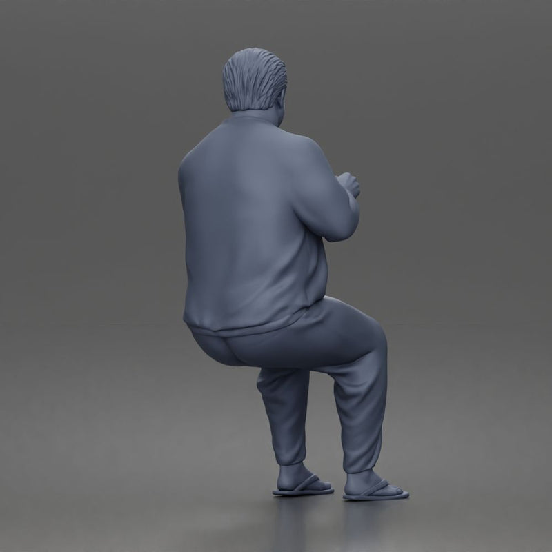 Asian Man sits gesturing while wearing casual sweater pants flip flops comfortably - Only-Games