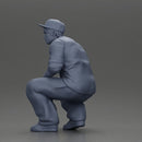 Gangster man crouching in a relaxed pose wearing casual clothing and cap - Only-Games