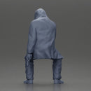 Man in hooded jacket sits alone holding gun feeling troubled - Only-Games