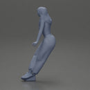 Woman sitting on car in red top yellow pants striking playful pose - Only-Games