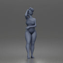 Standing woman shields eyes wearing swimsuit sunglasses earrings flip flops