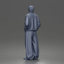 Urban male standing in varsity jacket and baggy trousers