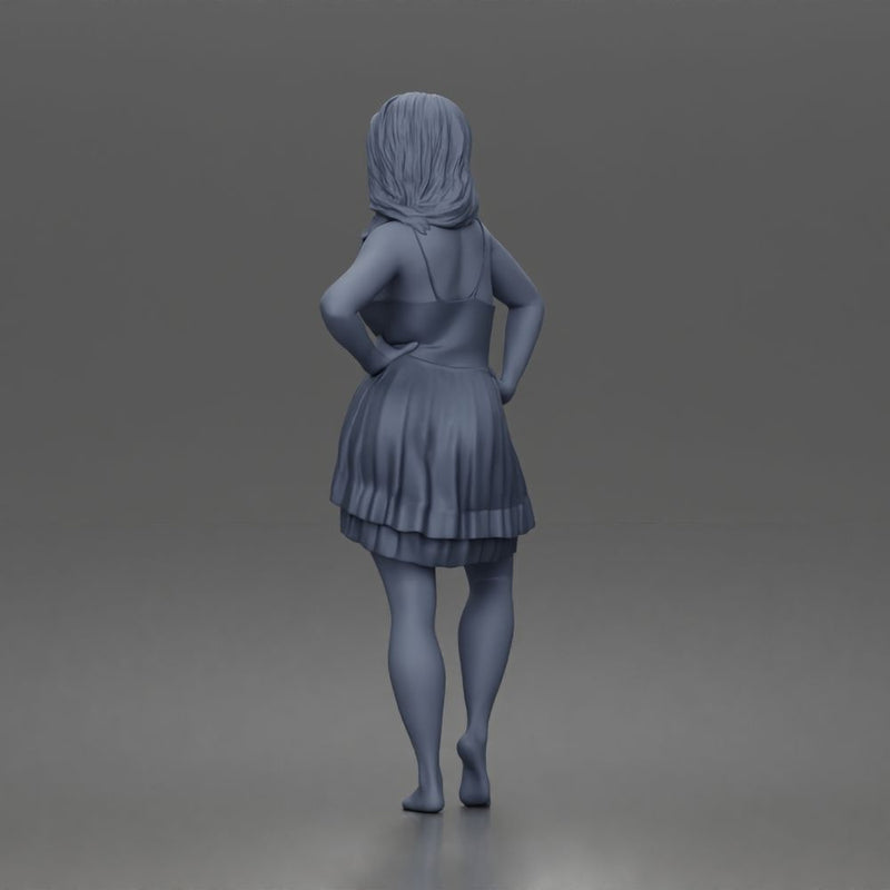 woman posing with hands on hips wearing ruffled dress