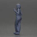 Woman with black hair wearing blue overalls holding a drink - Only-Games