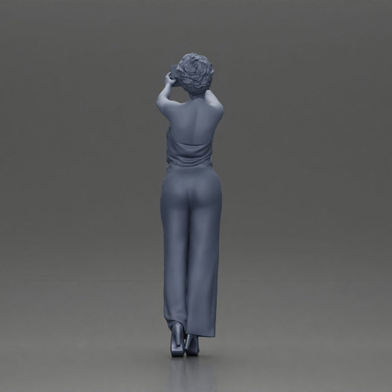 Fashionable woman in a jumpsuit snapping a selfie in style - Only-Games