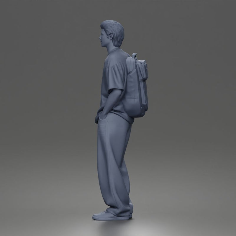 Student standing with backpack wearing oversized tee and baggy jeans