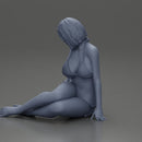 Woman in green bikini sitting gracefully on the floor with a relaxed pose - Only-Games