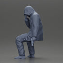 Man in hooded jacket sits alone holding gun feeling troubled - Only-Games