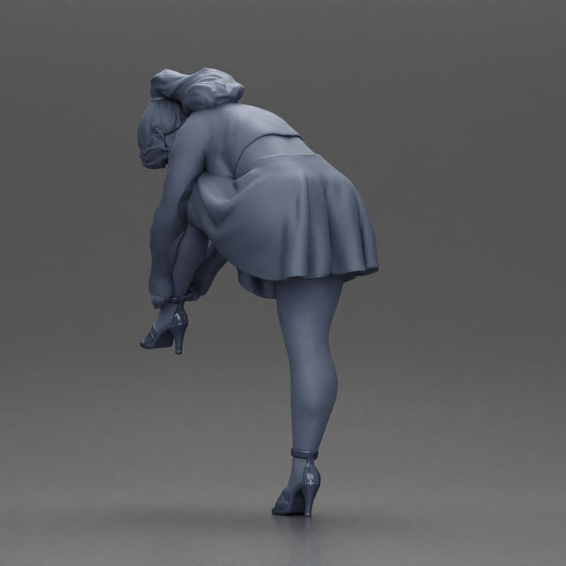 Young woman in skirt adjusts her elegant black high heeled shoes - Only-Games