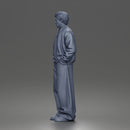 Urban male standing in varsity jacket and baggy trousers
