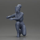 Fashionable woman kneeling in red jacket, green pants, and black boots - Only-Games