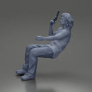 Man sitting with gun in hand pointing forward calmly - Only-Games