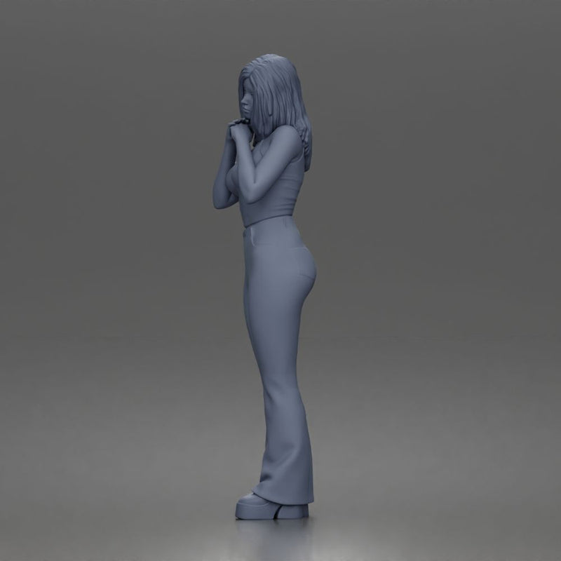 Thoughtful woman stands daydreaming wearing crop tank top and trousers - Only-Games
