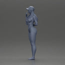 girl in a white bikini holding a phone on the beach and wearing a cap - Only-Games