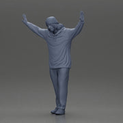 Man wearing hoodie and beanie raises hands looking happy in relaxed stance - Only-Games