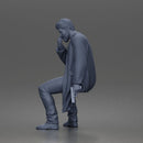 Seated Detective In Long Coat Holding Weapon In Contemplative Pose
