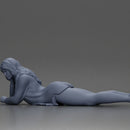 Girl with long hair in green dress lying with calm on the beach - Only-Games