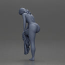 Woman in white top carefully wearing grey pants with balance - Only-Games