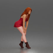 woman bending forward thoughtfully balancing gracefully in mini dress and boots - Only-Games
