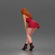 woman bending forward thoughtfully balancing gracefully in mini dress and boots - Only-Games