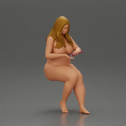 Naked Blonde woman sitting applies hand cream - Only-Games