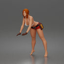 woman Pushing Tire In Bikini Top Shorts Tool Belt And Gloves