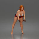 woman Pushing Tire In Bikini Top Shorts Tool Belt And Gloves