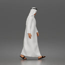 Walking man looking aside wearing traditional thobe headscarf and sandals