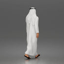 Walking man wearing thobe holding hands with woman wearing abaya