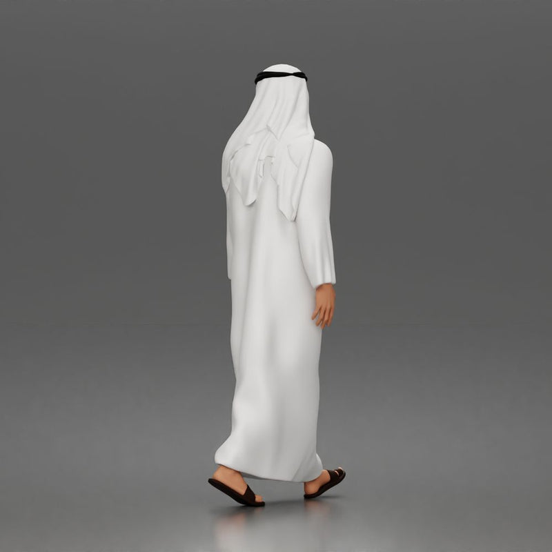 Walking man wearing thobe holding hands with woman wearing abaya