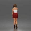 Elegant Woman Standing Gracefully Wearing Strapless Top Skirt And Boots