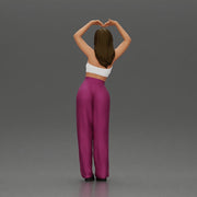 woman striking a heart-shaped pose with joyful energy - Only-Games