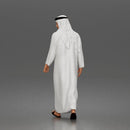 Walking man looking aside wearing traditional thobe headscarf and sandals