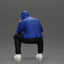 Thoughtful Man in Hoodie Squatting with Hand on His Face - Only-Games