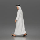 Walking man looking aside wearing traditional thobe headscarf and sandals