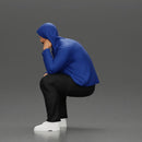 Thoughtful Man in Hoodie Squatting with Hand on His Face - Only-Games