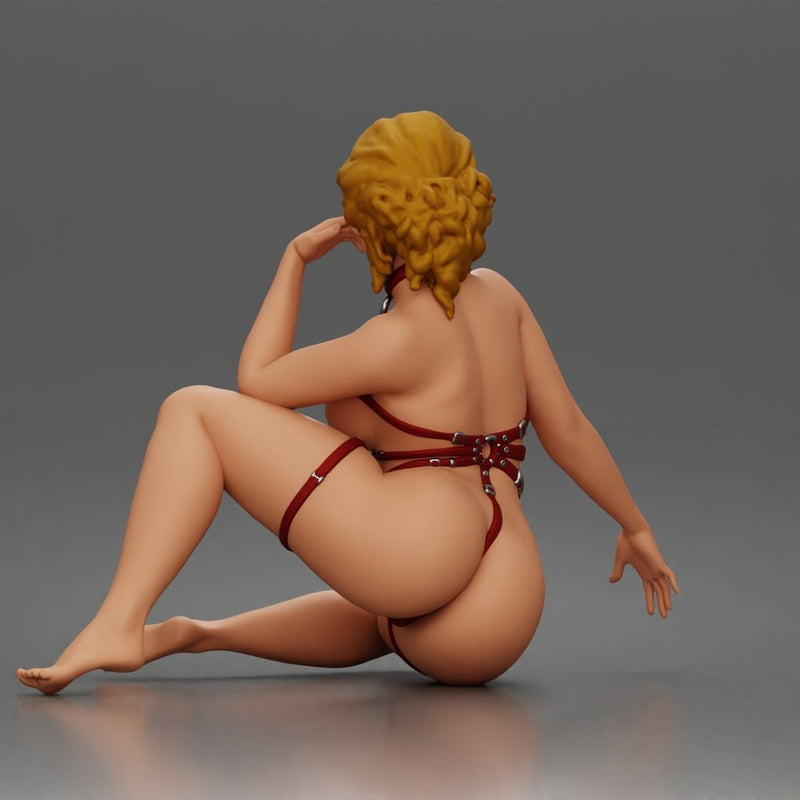 Thoughtful woman sits cross legged wearing strappy harness lingerie set - Only-Games