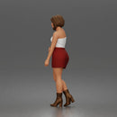 Elegant Woman Standing Gracefully Wearing Strapless Top Skirt And Boots
