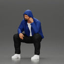 Thoughtful Man in Hoodie Squatting with Hand on His Face - Only-Games